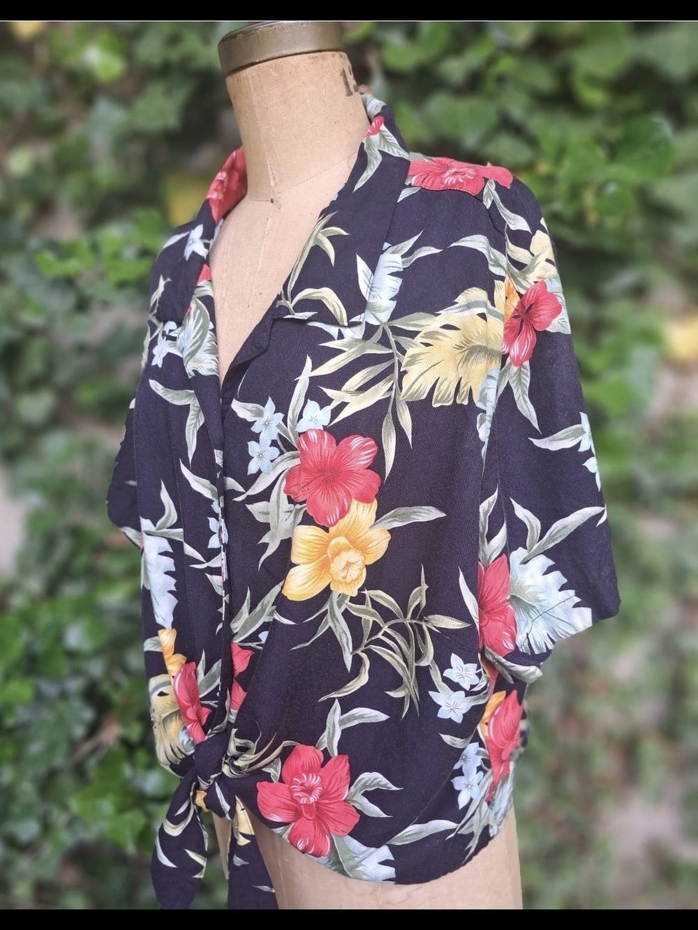 Caribbean Joe short-sleeve shirt features a vibrant tropical floral pattern on a